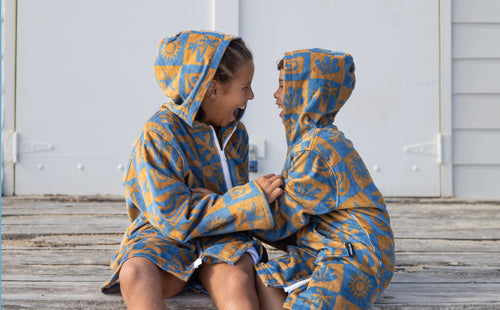 kids having fun wearing zip up beach towel robe