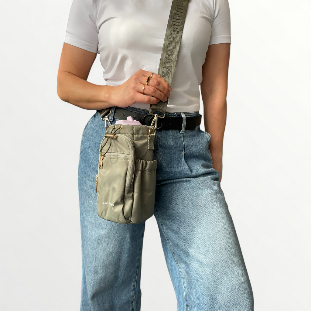 Khaki green drink bottle carry bag with gold accents and 'Sunreal Days' branding. Zipped pockets to hold phone and keys.