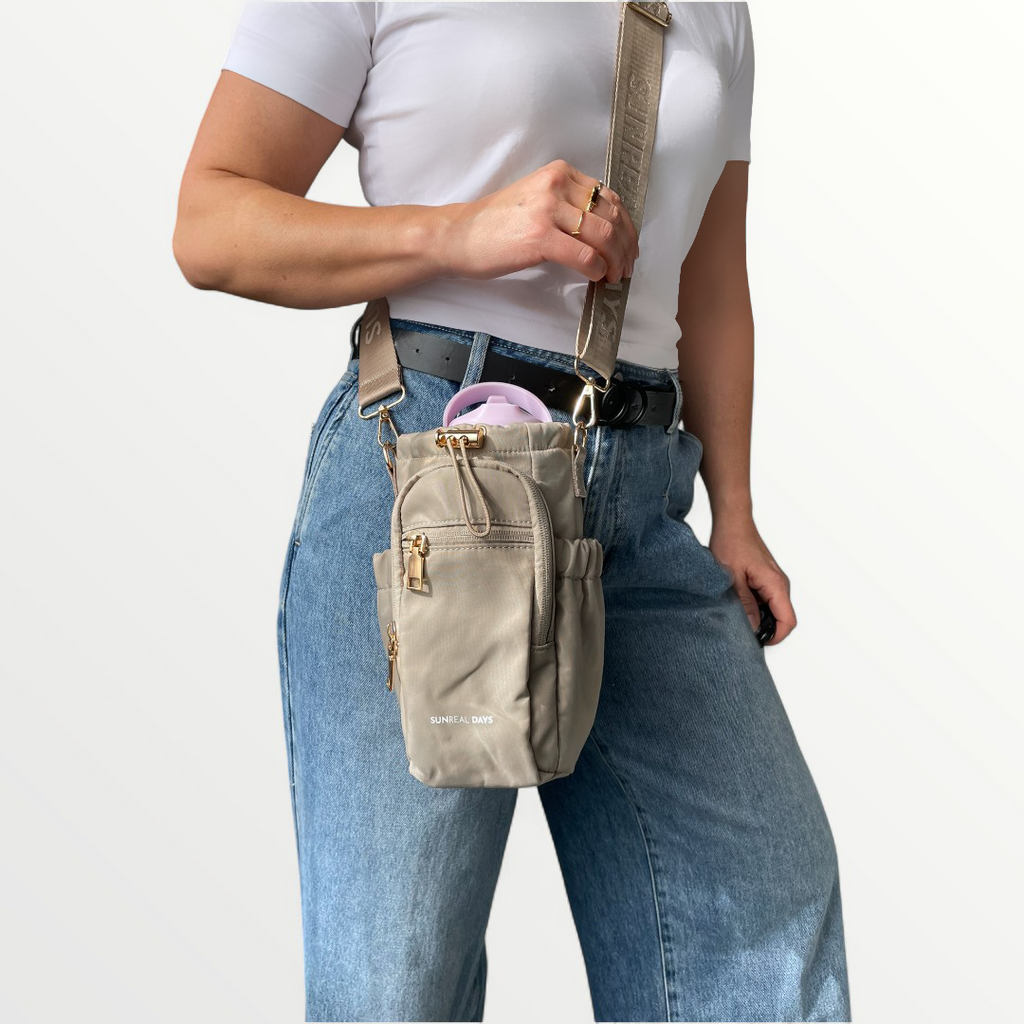 person carrying a drink bottle bag in soft dune colour.